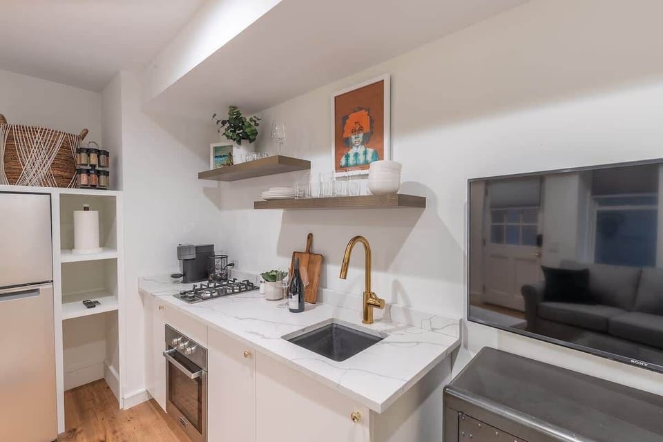 Full kitchen includes a small oven, two burner stovetop, coffee maker, fridge/freezer and other essentials!