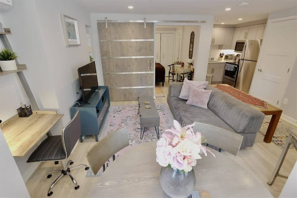 Dining table doubles as a laptop friendly workspace, as well as the desk area