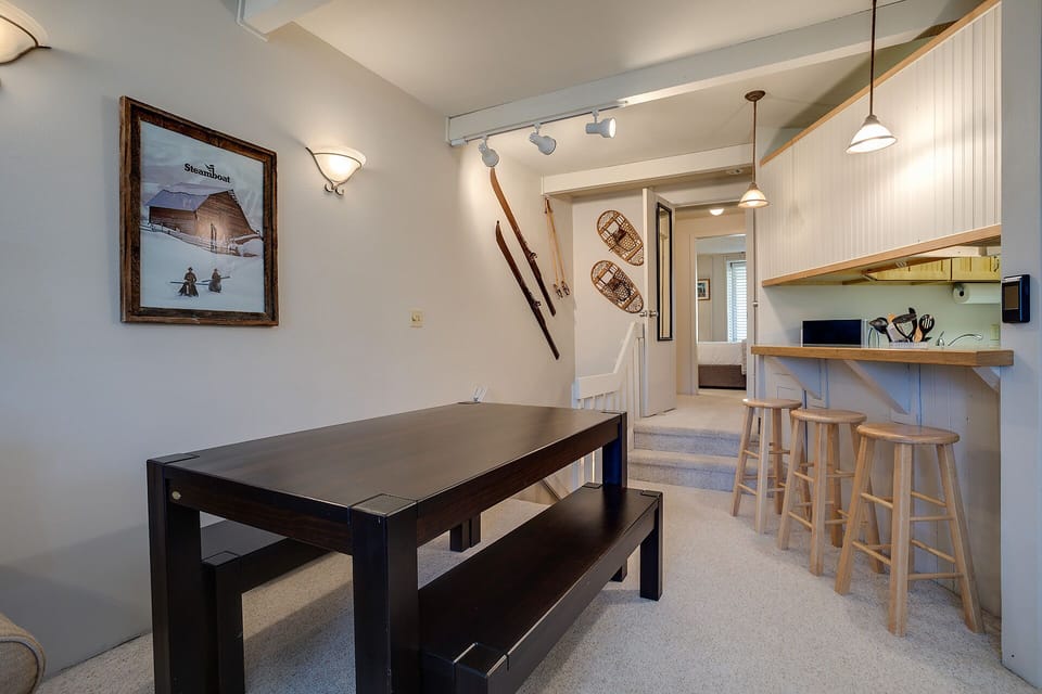 Your cozy ski-themed dining area features rustic charm with vintage snowshoes and mountain artwork setting the perfect après-ski mood.