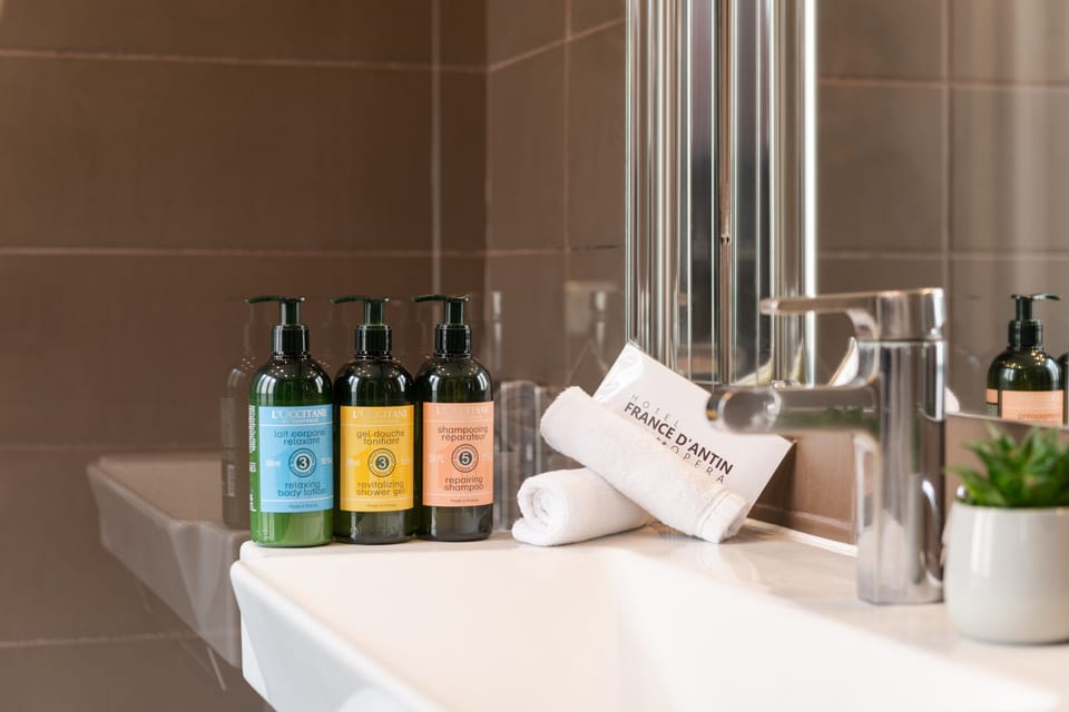 Designer toiletries, hair dryer, slippers, towels
