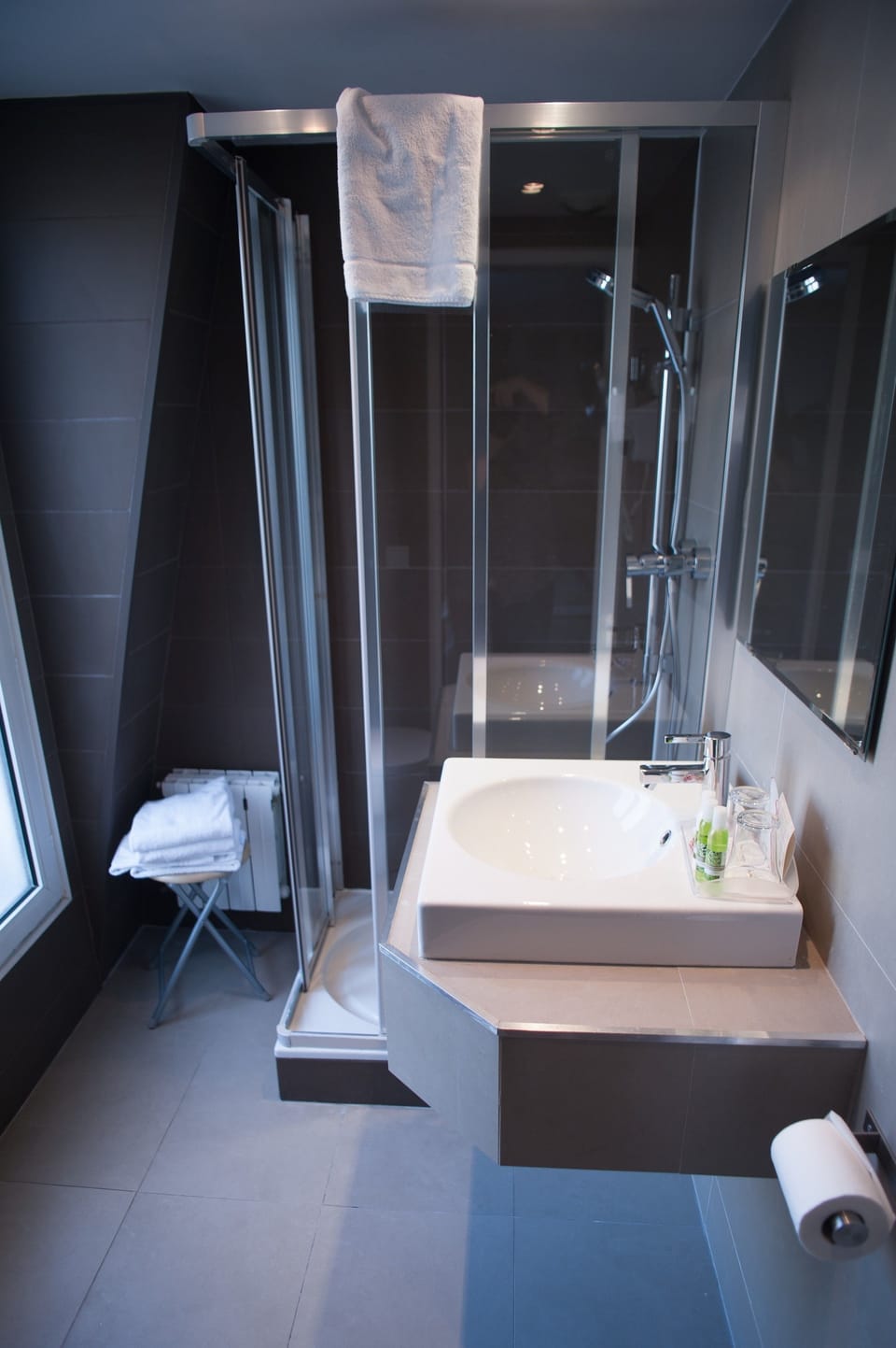 Bathroom | Designer toiletries, hair dryer, slippers, towels