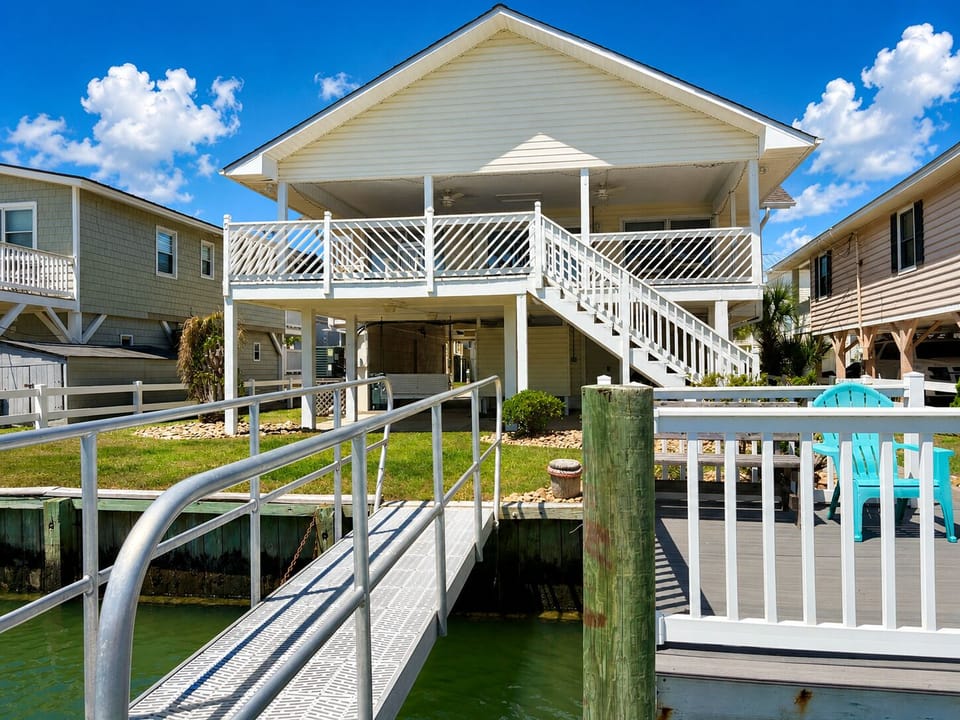 Dock view of the back of the home, showing covered porch