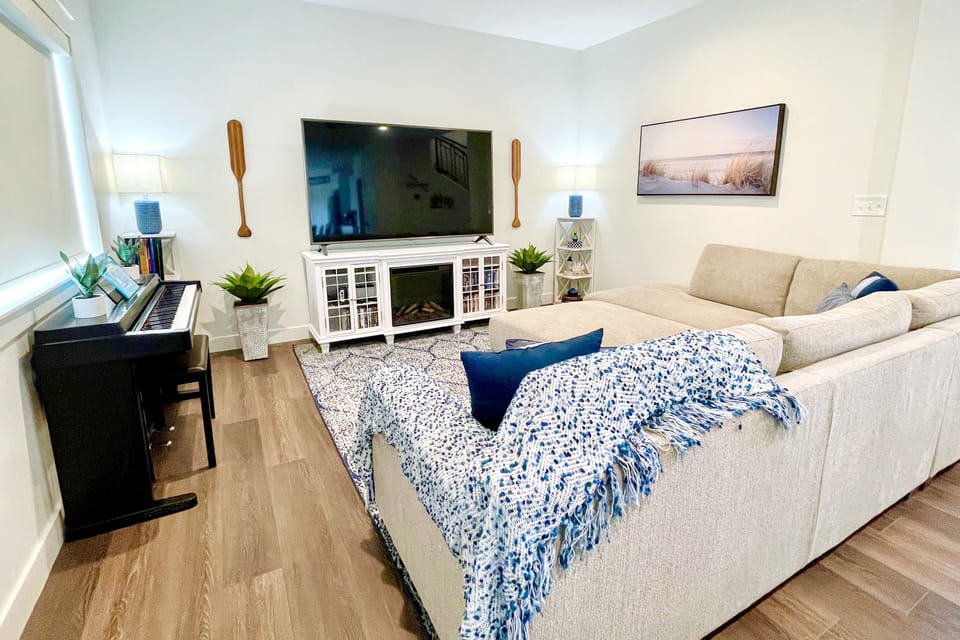 Family room w/ Nintendo Switch, piano and a selection of piano books