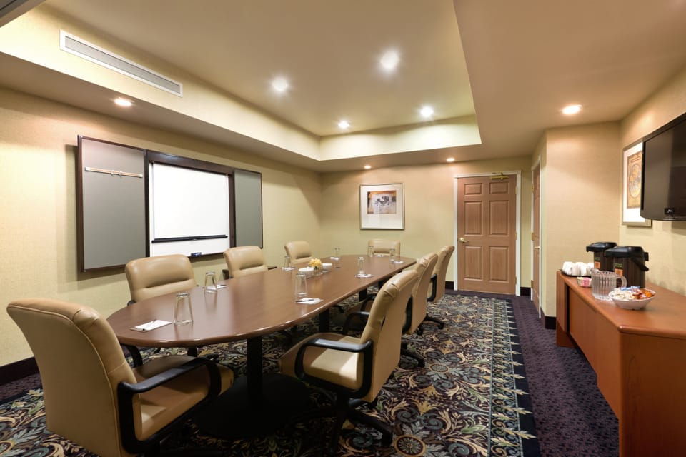 Meeting room with presentation screen and refreshments.