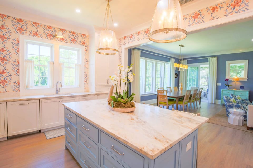 The kitchen features a center island with marble counters.