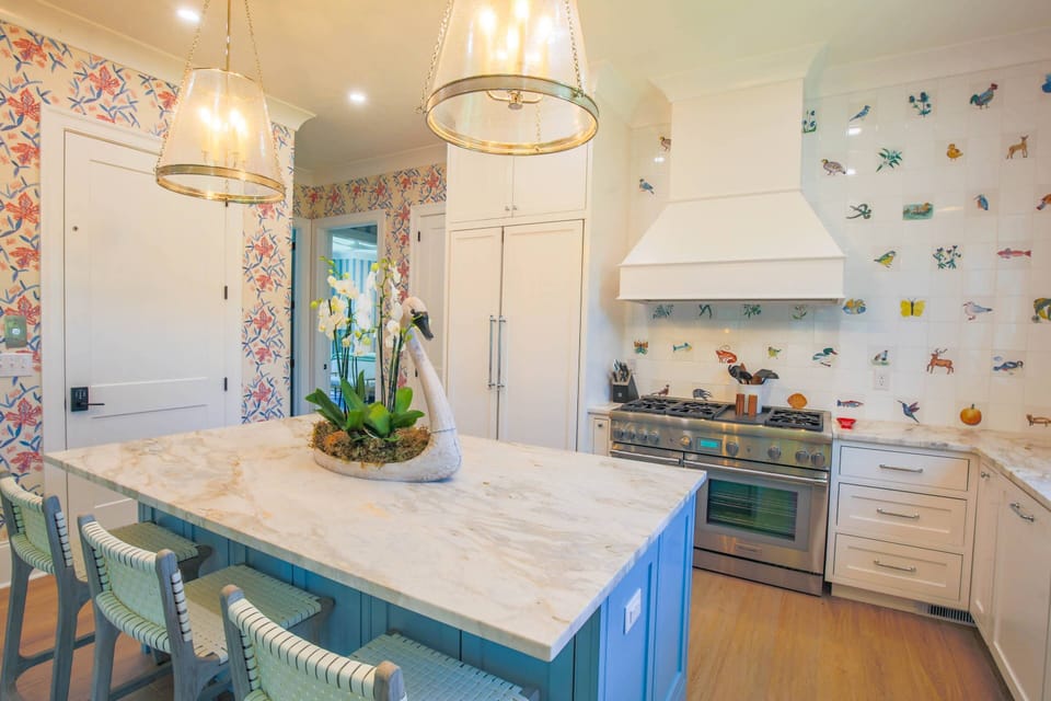 The kitchen features a built-in Thermador refrigerator and double oven range.