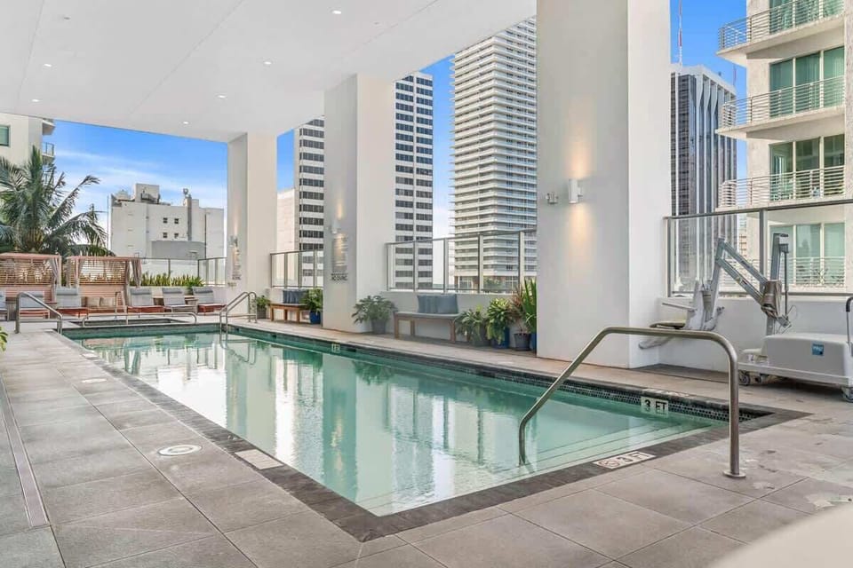 Pool deck with hot tub and sun beds