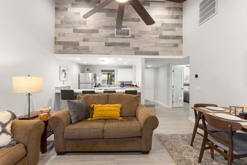 Tile wall and seating at quartz counter.