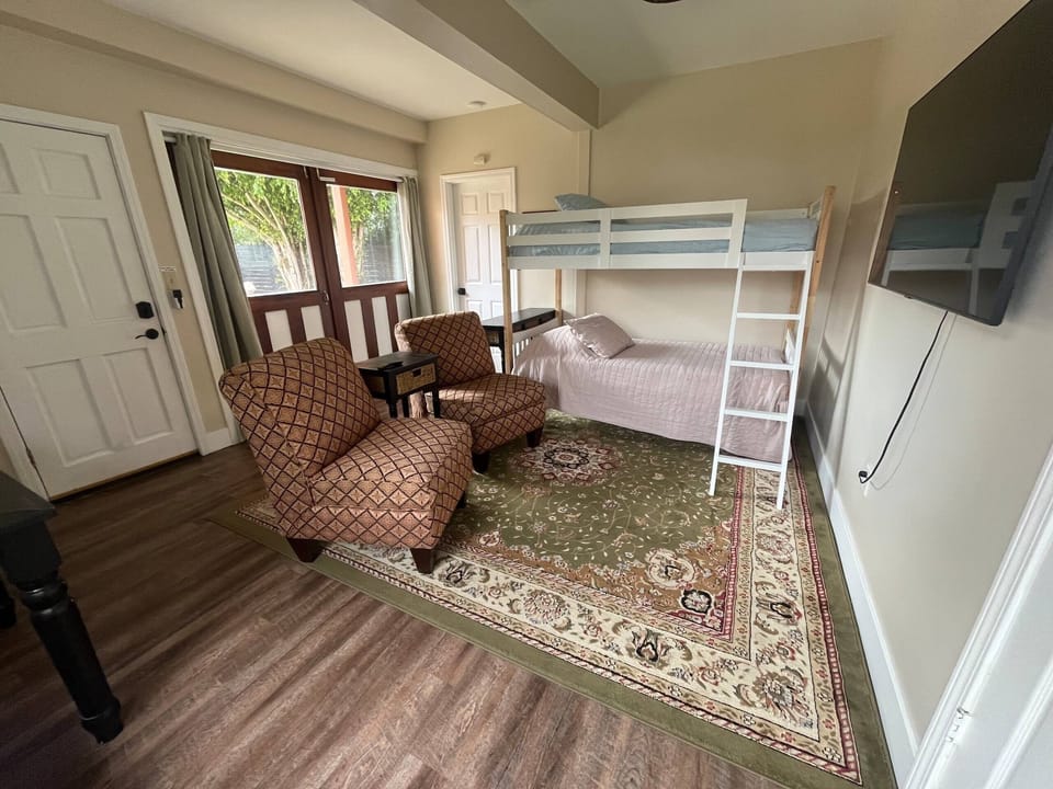 TV room in carriage house with bunk beds adjoining bedroom with queen bed