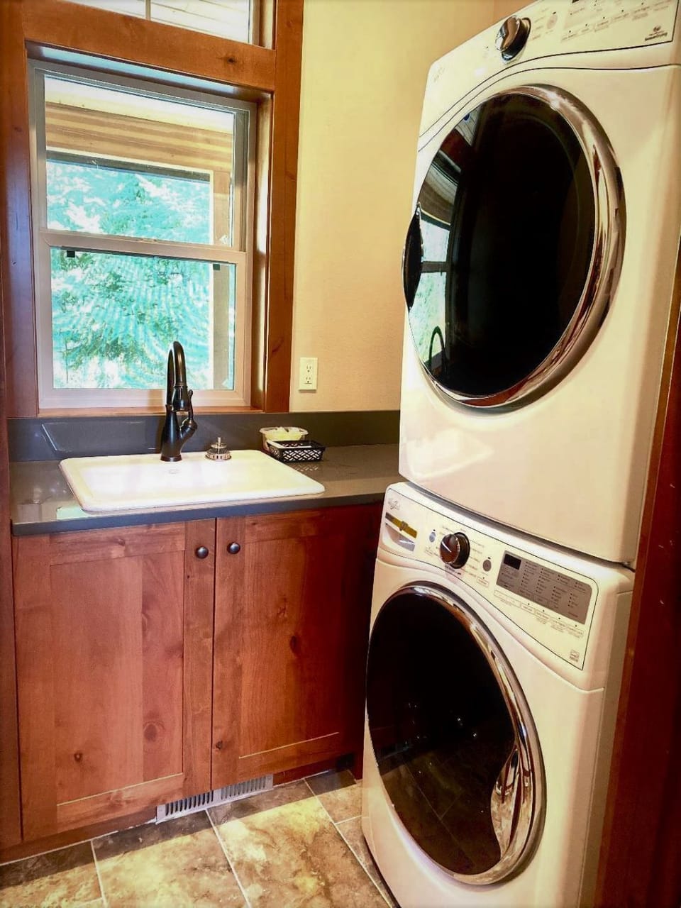Laundry room with a full size stackable washer and dryer