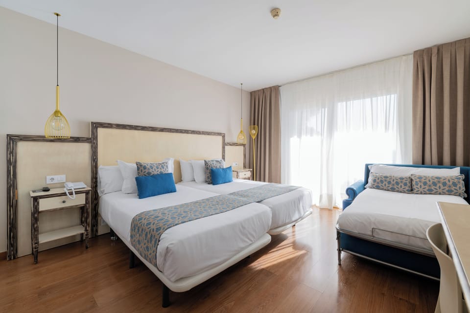 Comfort Triple Room, Sea View | Minibar, in-room safe, desk, blackout drapes