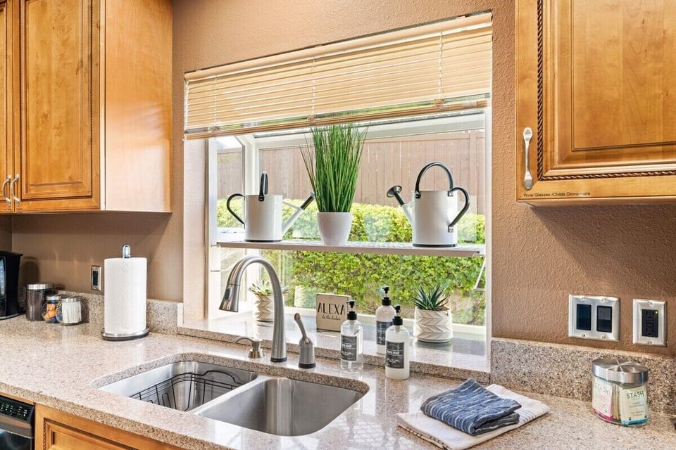 Experience the sleek and modern design of the stainless steel sink in this contemporary kitchen. The stainless-steel material not only adds a touch of elegance but also offers durability and easy maintenance.