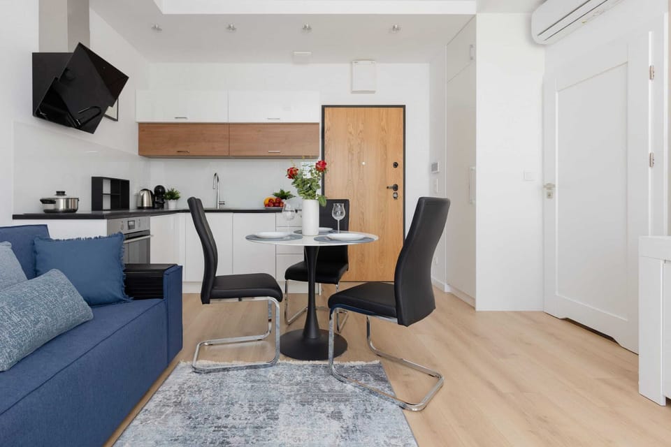 A connected view of the living, dining, and kitchen areas showcasing the apartment's flow and functionality.
