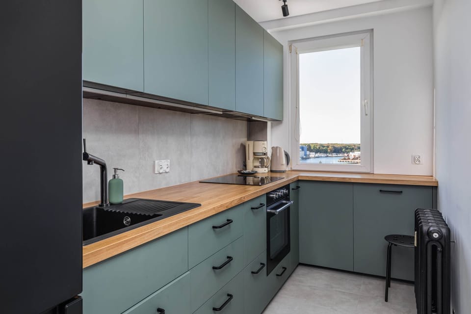 Another angle of the kitchen, showing its efficient layout and clean countertops.
