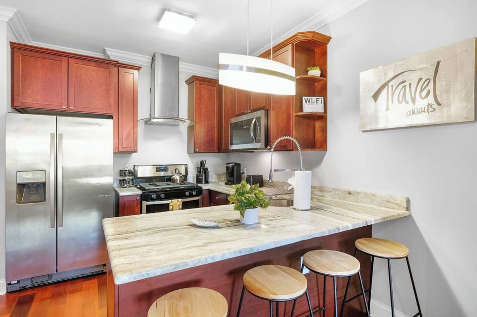 Full chef's kitchen with stainless steel appliances, granite countertops, cherry wood cabinets, and complete cookware.