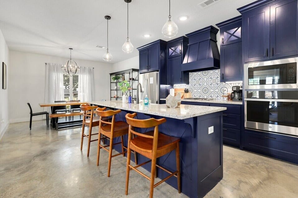 Our granite island and three barstools sit in the center of this space.