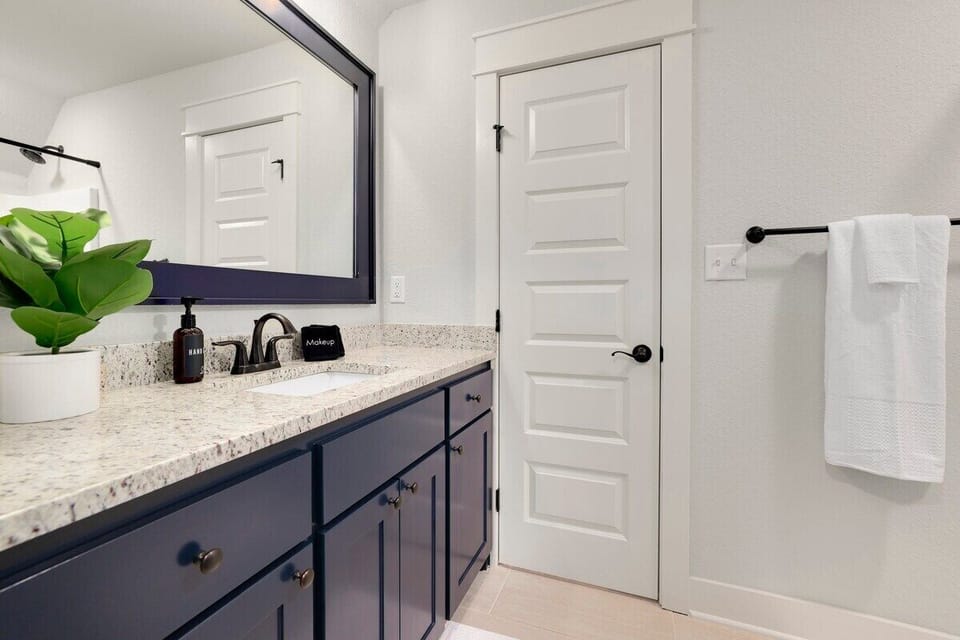 Our second Primary bathroom has a single sink, combination tub/shower and plenty of counter space.