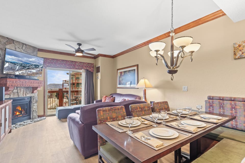 Gather around your elegant dining table for memorable meals, with a cozy fireplace creating the perfect ambiance.