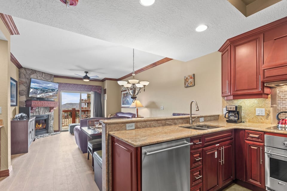 Your fully equipped kitchen features rich wood cabinetry, granite countertops, and stainless steel appliances.