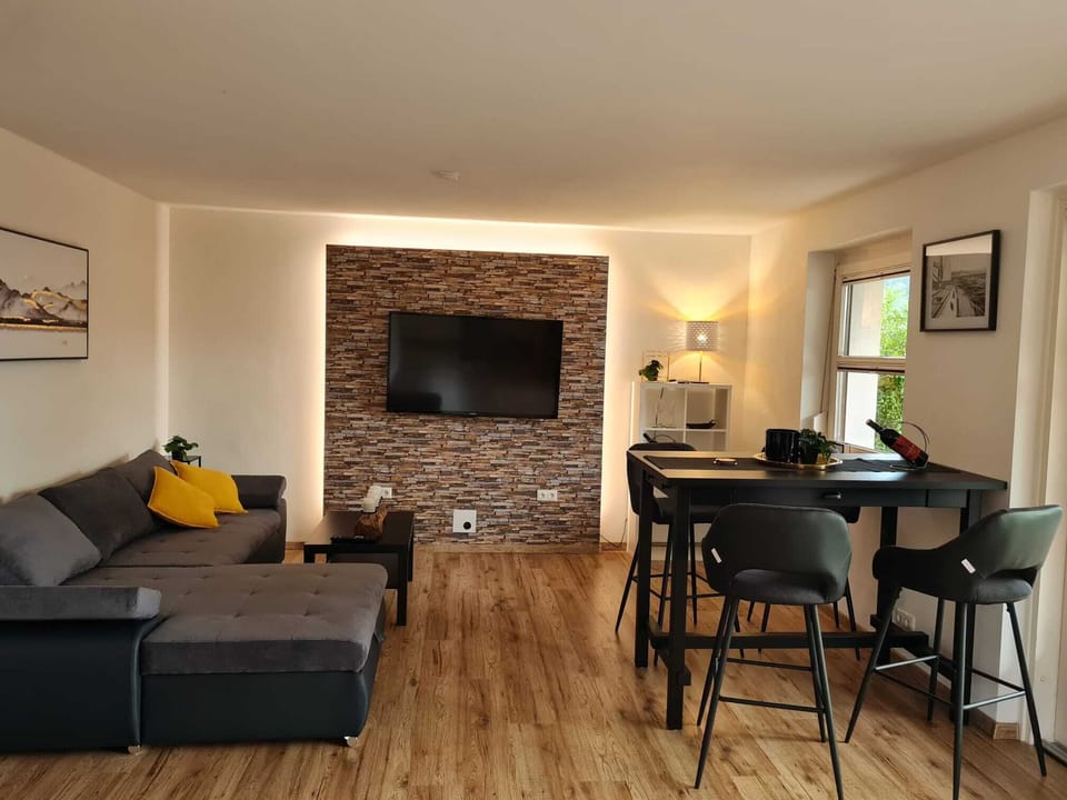 Deluxe Condo | Living area | 32-inch flat-screen TV with satellite channels, TV