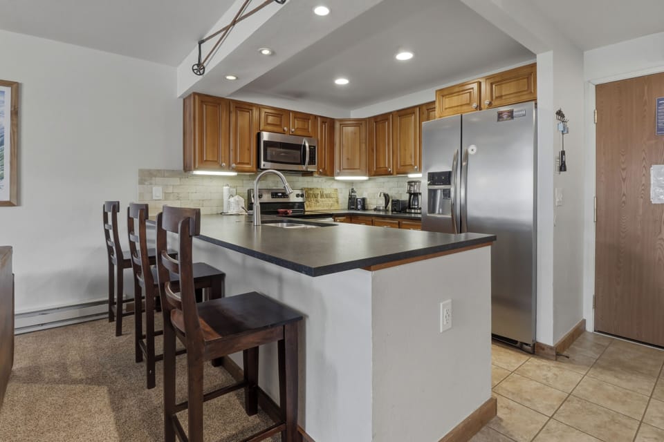 Your fully equipped kitchen features modern appliances, breakfast bar seating, and everything you need to create memorable meals during your stay.