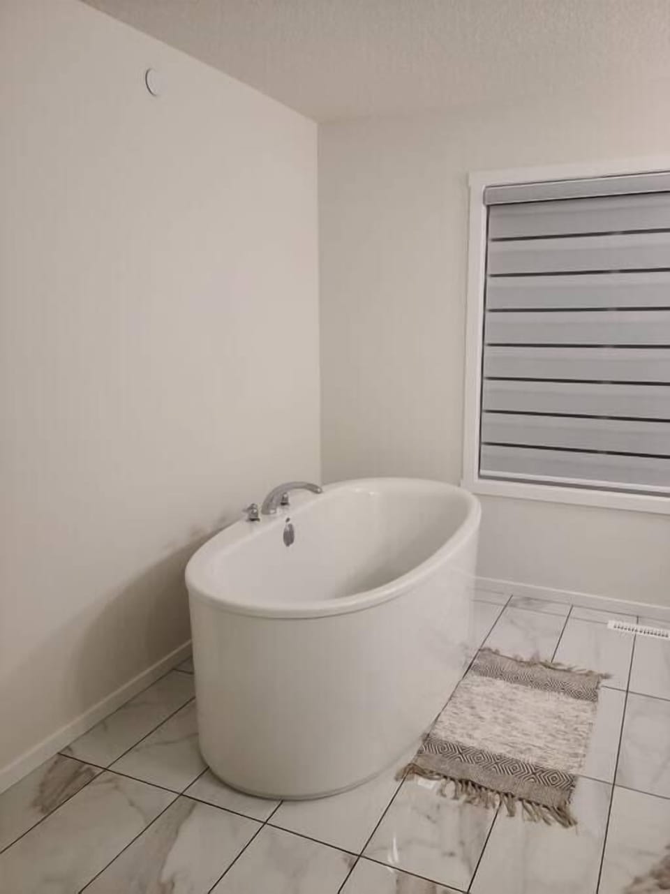 In-suite bathroom with a bathtub, large mirror direct access to bathroom