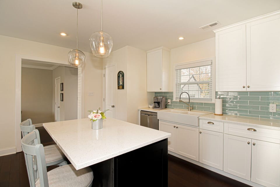 Access the living room, utility room with W/D, and door to the backyard via the doorway on the left.