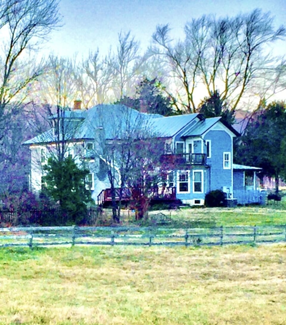 Back of our remodeled farm home, fenced pastures on all sides. 