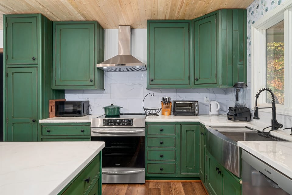 Kitchen with ample counter tops, large island, breakfast bar seating
