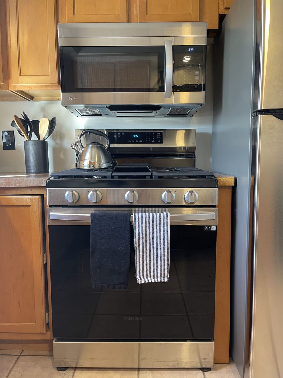 Brand new gas range with griddle and new microwave above 