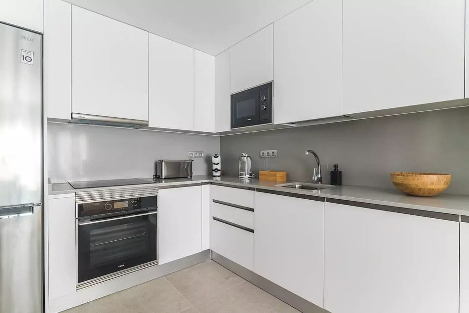 Full Kitchen equipped with fridge, oven, stove, and storage