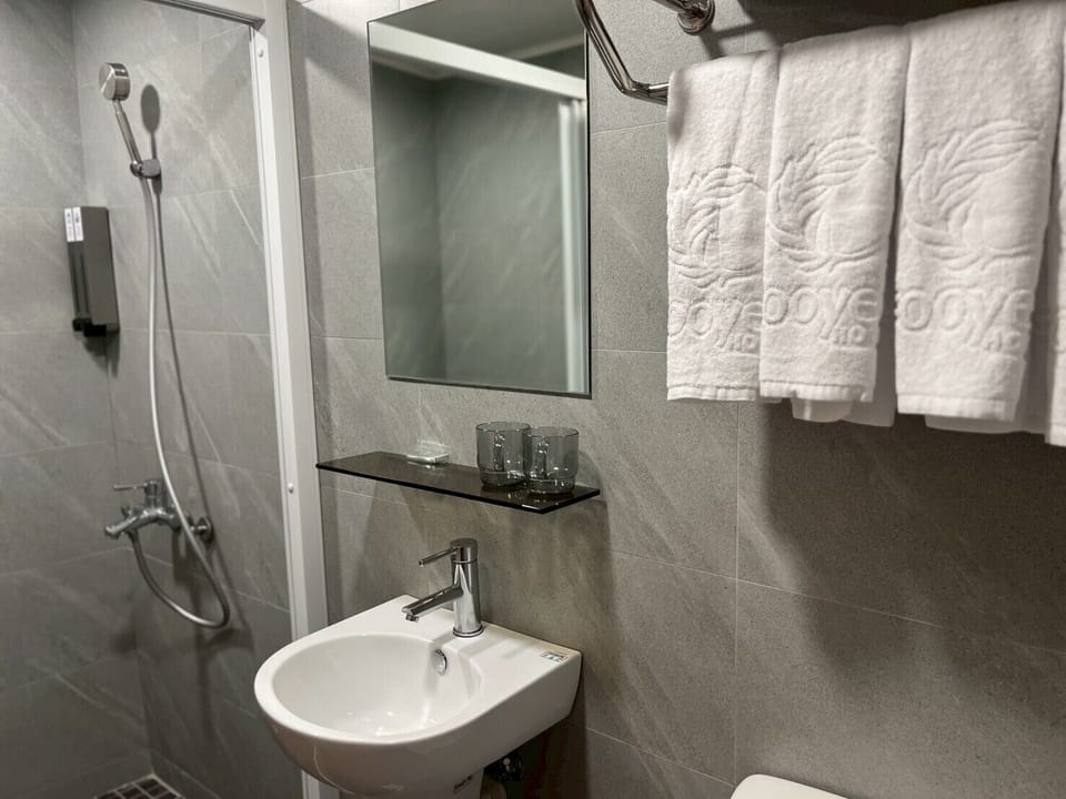 Family Quadruple Room, 2 Queen Beds | Bathroom | Shower, hydromassage showerhead, hair dryer, slippers