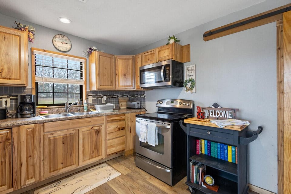 Full kitchen with stove, microwave and refrigerator.