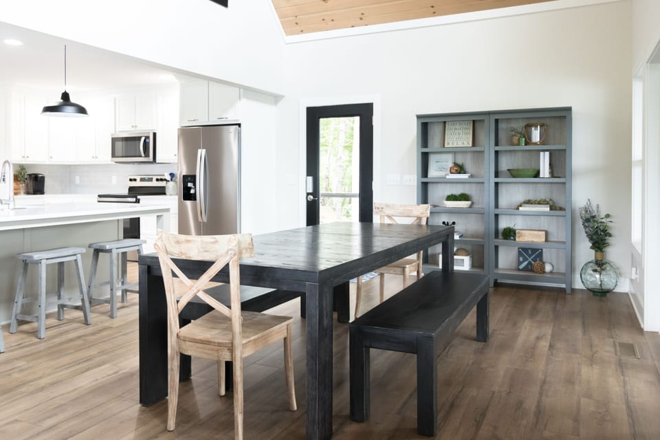 Dinning area with large table, sliding glass doors to screen porch.