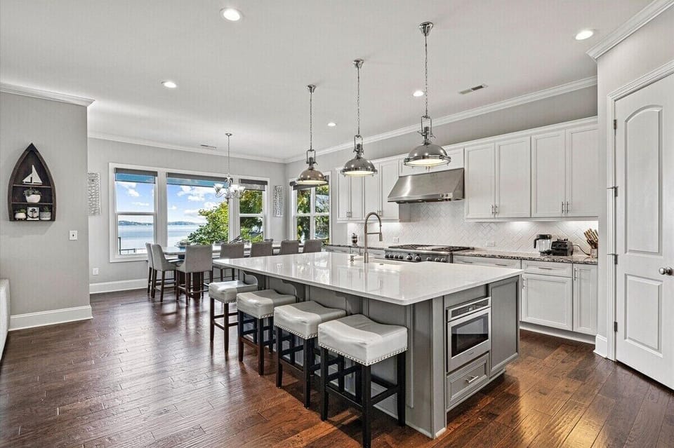 Main level chef kitchen with dinning table for 14 and additional seating around island.