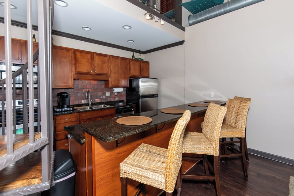 Your fully equipped kitchen features rich cherry cabinets, granite counters, and stainless appliances, perfect for preparing memorable meals together.