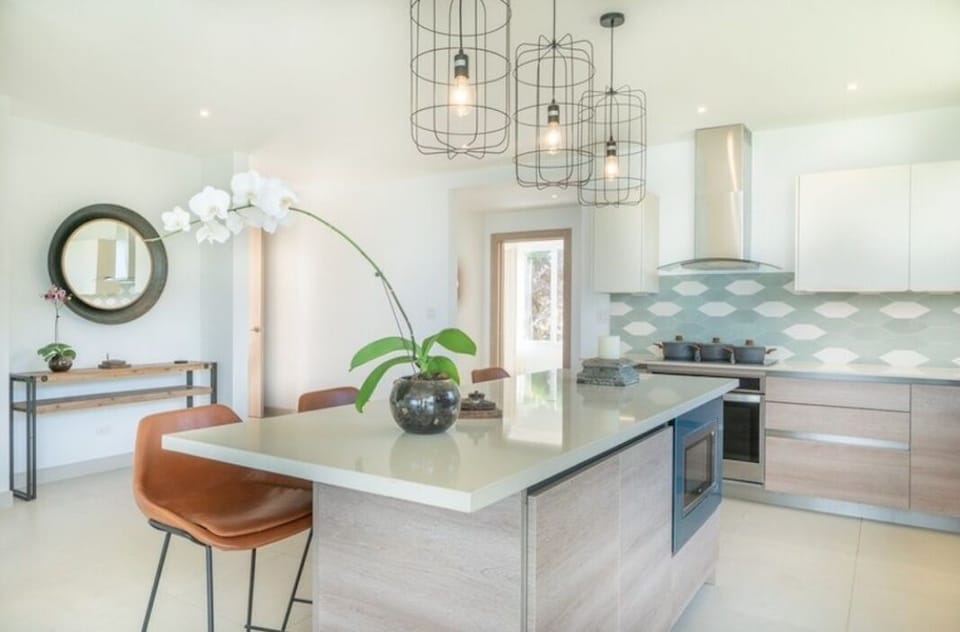 The kitchen island is perfect to gather around for food & drink!