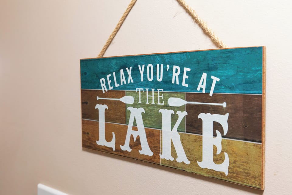 A charming lake-themed sign sets the perfect mood for your peaceful getaway retreat.