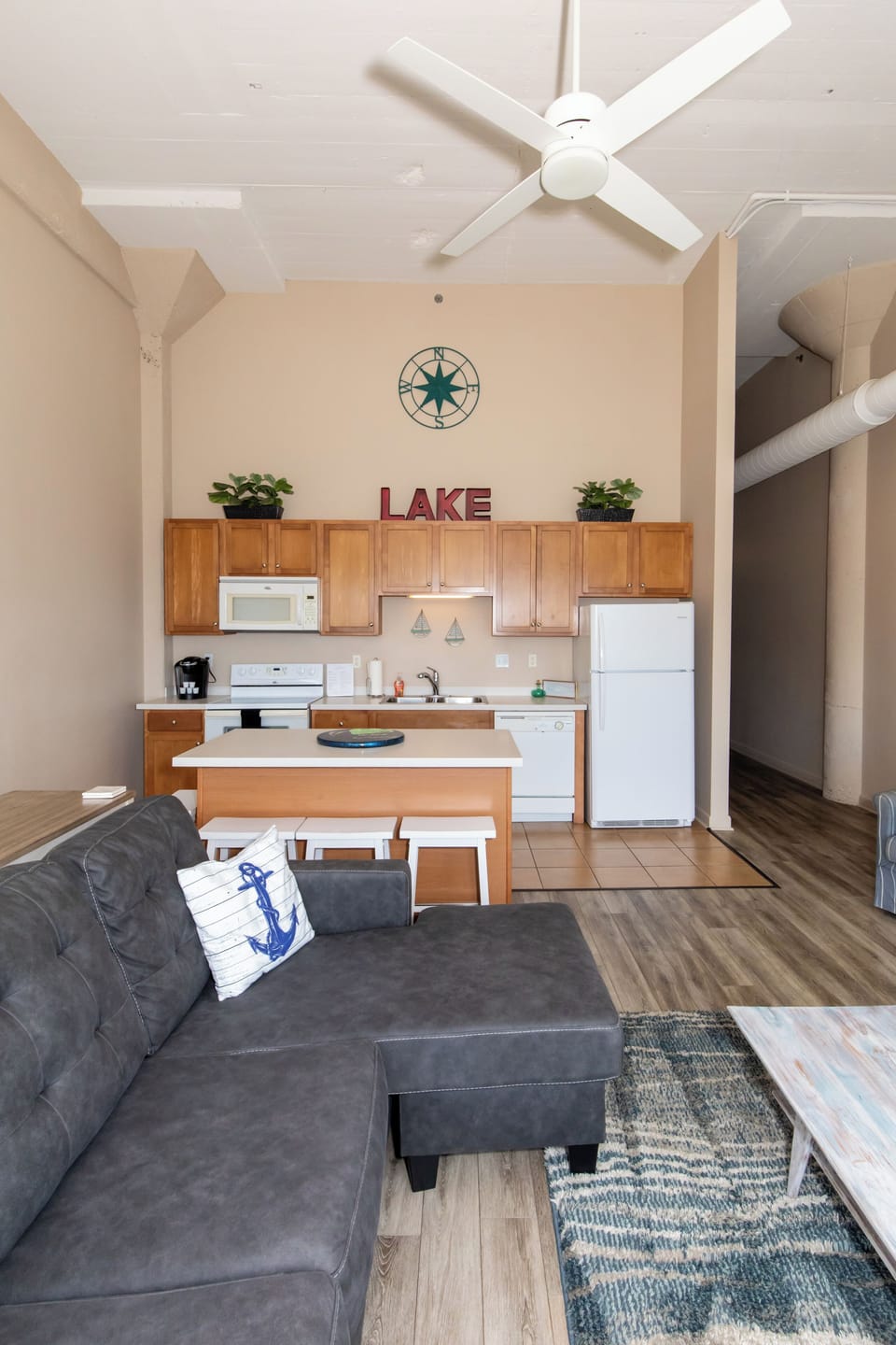 Your open-concept space flows seamlessly from cozy living area to fully equipped kitchen, perfect for lakeside relaxation.