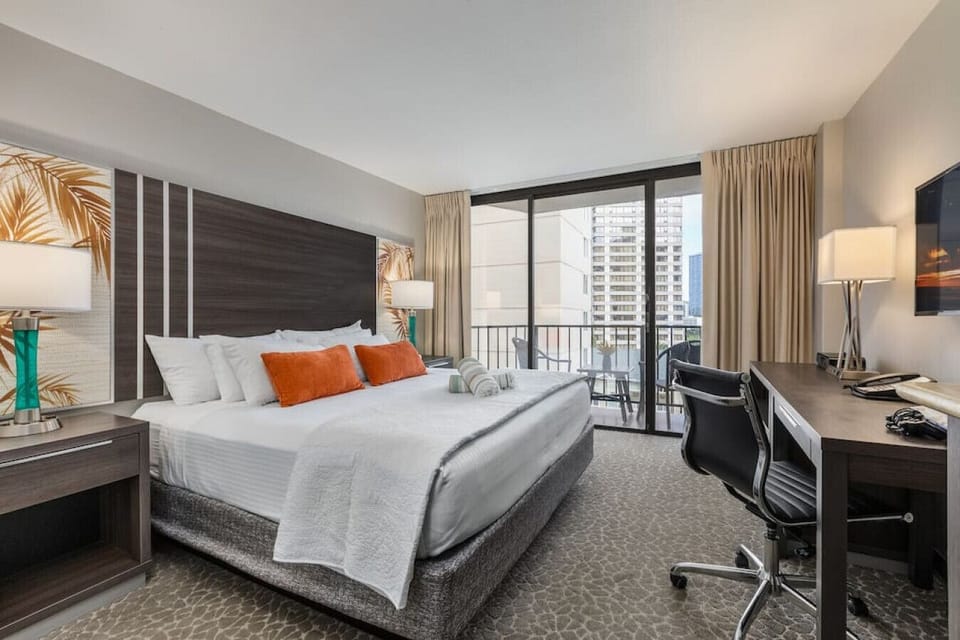 Bright bedroom retreat w/ cozy seating & soft light for easy unwind.