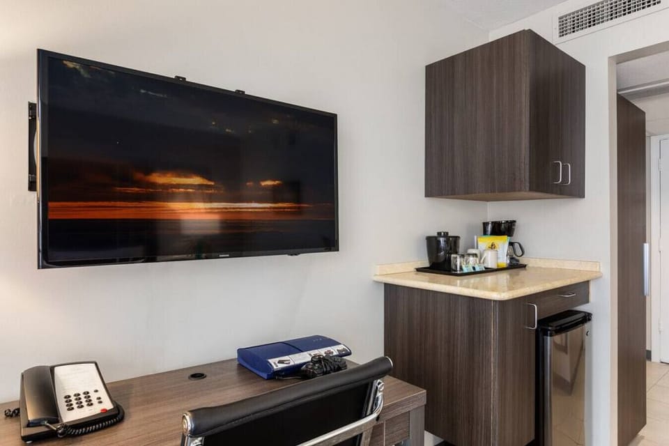 Cozy office nook w/ TV & storage for relaxed work sessions.