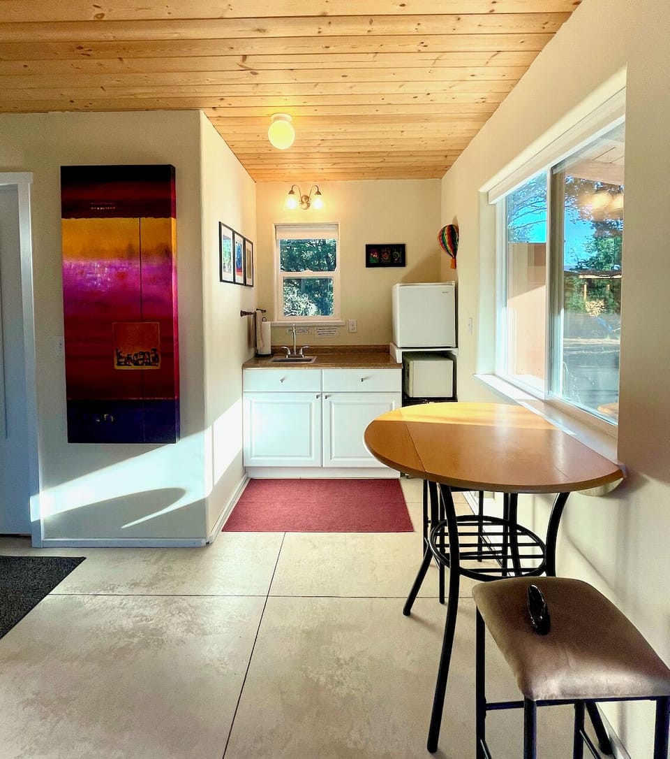 The kitchenette has a mini fridge, microwave, hot plate, toaster oven, dishes.