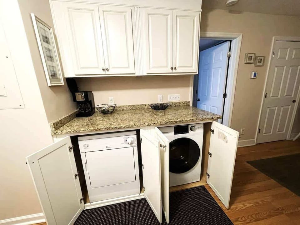A tucked-away washer and dryer are available right in the kitchen area.