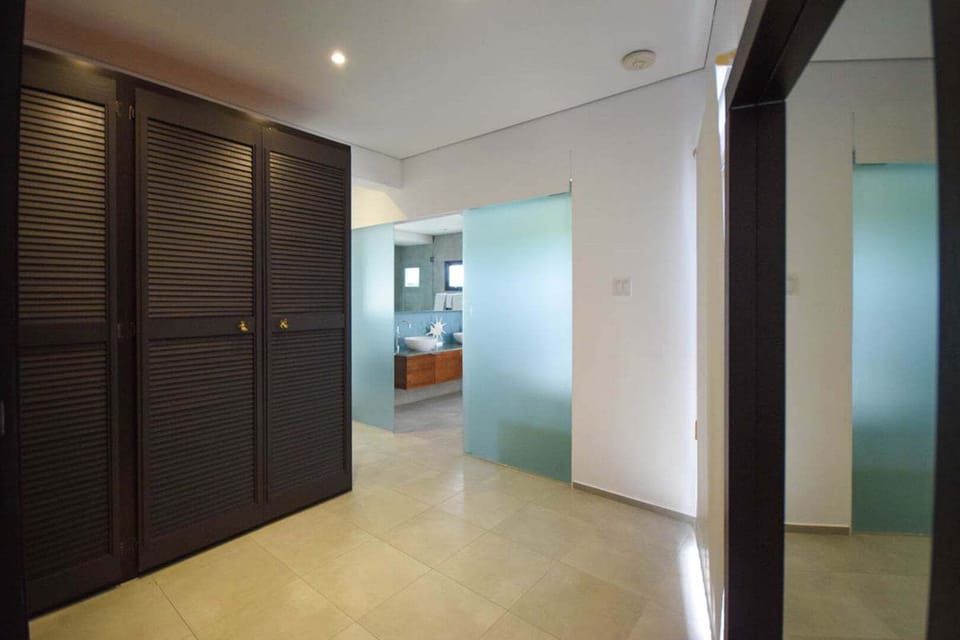 Master bedroom walk-in closet leading to the en-suite bathroom