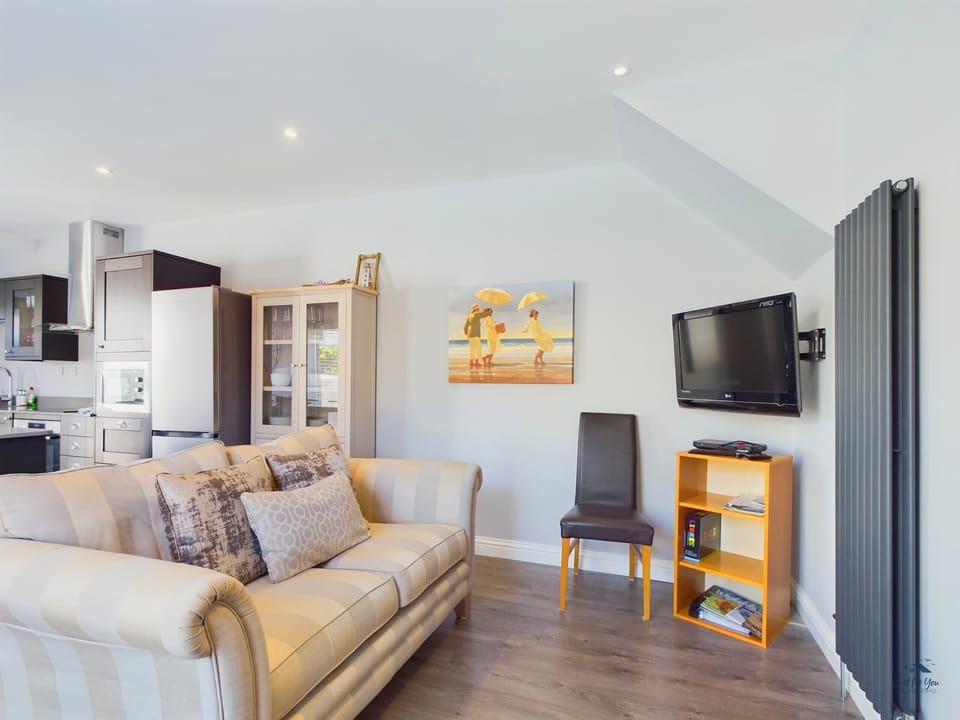 The secondary sitting area features a Smart TV, providing a perfect spot for children or casual morning news.