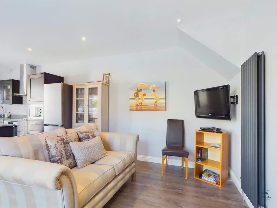 The secondary sitting area features a Smart TV, providing a perfect spot for children or casual morning news.