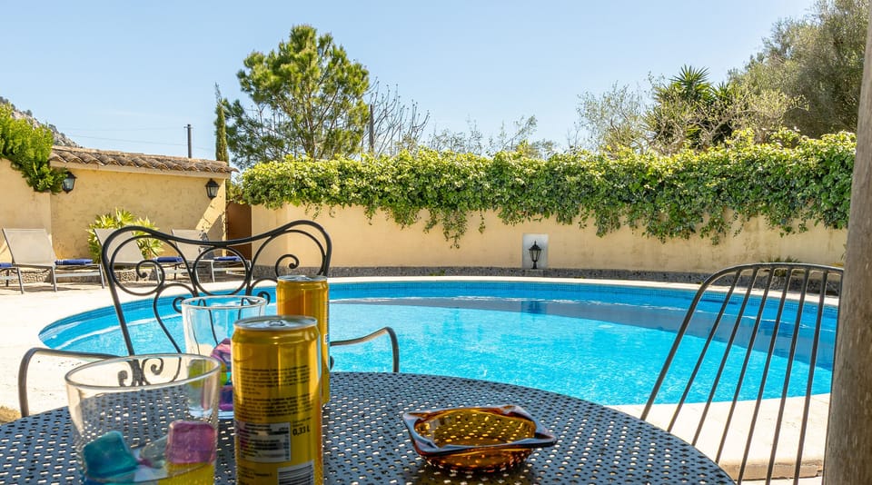 Table with drinks in front of the private pool at La Sort Llarga, Pollença