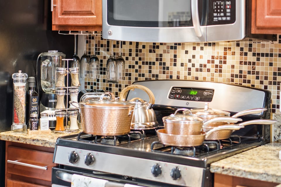 Gas stove with pots and pans.  