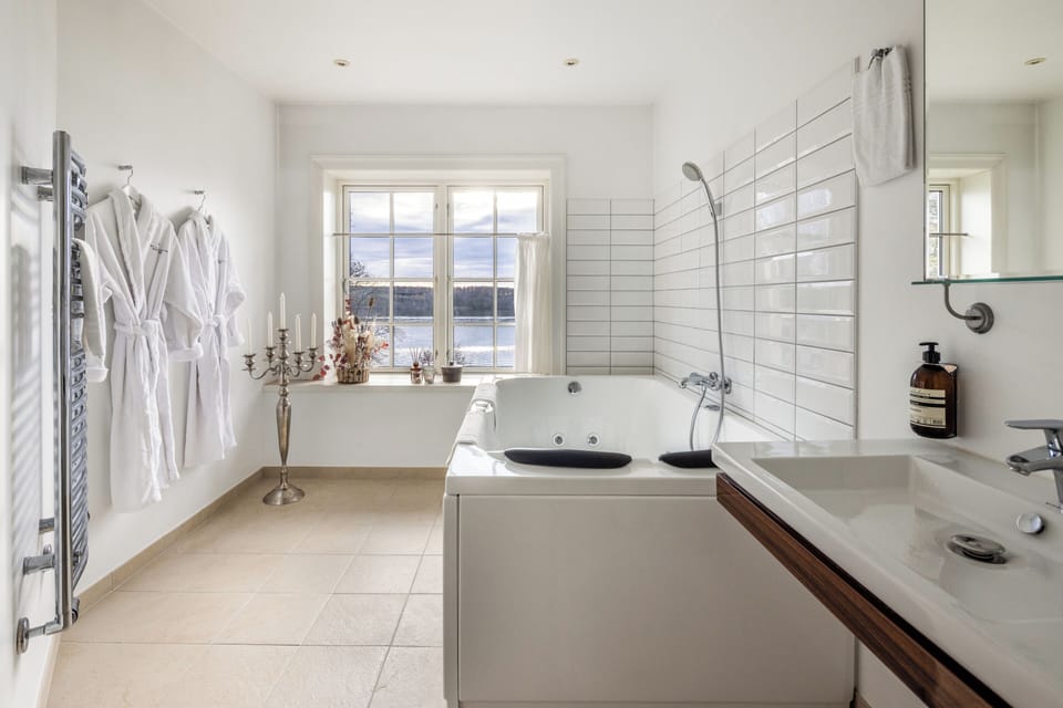Junior Suite, Jetted Tub, Sea View | Bathroom | Free toiletries, hair dryer, slippers, heated floors