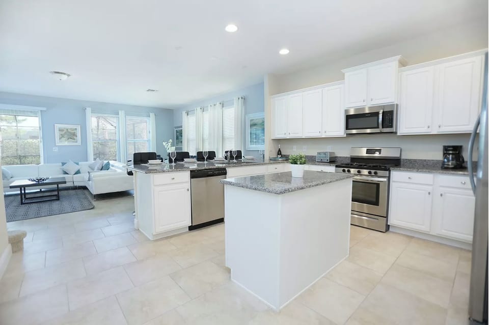 Well stocked kitchen with island and bar.